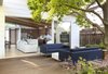 Modern home with Outdoor, Wood Fences, Wall, Wood Patio, Porch, Deck, Back Yard, Flowers, Trees, Garden, and Small Patio, Porch, Deck. Large sliders blur the line between indoors and out and expand the living space. Photo 5 of Hedge