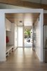 Modern home with Hallway and Light Hardwood Floor. Built in storage keeps the entryway clear of clutter. Photo 6 of Hedge