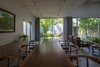 Modern home with Dining Room, Chair, Ceramic Tile Floor, Ceiling Lighting, and Table. The house faces west, has an artificial lake and a large tree garden, which helps to cover the sun and regulate the air into the house. Photo 4 of Ninh Binh House