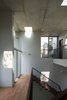 Modern home with Hallway and Medium Hardwood Floor. The large void connects all the spaces of the house, enabling people to interact with each other and be closer to nature. Photo 7 of Ninh Binh House