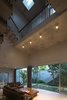 Modern home with Living Room, Ceramic Tile Floor, Sofa, Ceiling Lighting, and Coffee Tables. Throughout the day, people always feel connected to the garden, with trees, wind and light. Nature becomes part of everyday life. Photo 16 of Ninh Binh House