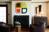 Modern home with Living Room, Medium Hardwood Floor, Console Tables, Wood Burning Fireplace, Chair, Lamps, Standard Layout Fireplace, End Tables, Table Lighting, and Storage. The muted guestroom palette makes way for white oak subtly trimmed in Shinola blue.
Photo 7 of The Shinola Hotel