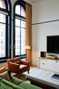 Modern home with Living Room, Bench, Medium Hardwood Floor, Floor Lighting, Chair, Media Cabinet, Console Tables, Lamps, Coffee Tables, and Rug Floor. Shinola’s Runwell turntables add a touch of retro intrigue.
Photo 9 of The Shinola Hotel