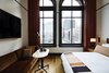 Modern home with Bedroom, Medium Hardwood Floor, Floor Lighting, Chair, Bed, Night Stands, Rug Floor, Wall Lighting, and Lamps. Oversized windows forge a connection with downtown Detroit.
Photo 6 of The Shinola Hotel