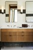 Modern home with Bath Room, Undermount Sink, Wall Lighting, Ceramic Tile Wall, Ceramic Tile Floor, Subway Tile Wall, and Marble Counter. Gleaming, warm baths feature products inspired by T.B. Rayl’s, one of the building’s previous occupants.
Photo 11 of The Shinola Hotel