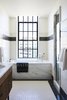 Modern home with Bath Room, Subway Tile Wall, Undermount Tub, Marble Counter, Ceramic Tile Floor, Ceramic Tile Wall, Alcove Tub, Recessed Lighting, and Undermount Sink. Bathrooms incorporate custom glazed tile and Imperial Danby stone quarried in Vermont.
Photo 10 of The Shinola Hotel