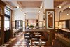 Modern home with Ceramic Tile Floor, Bench, Pendant Lighting, Chair, and Wall Lighting. In the restaurant San Morello, a palette of soft brown, white, and blue is amplified by soaring window panels.
Photo 12 of The Shinola Hotel