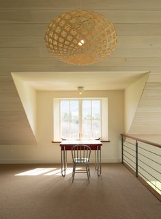 A retro desk provides a space for quiet time in the uncluttered loft.