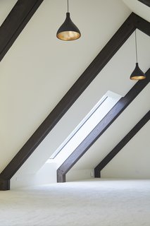 Natural light pours through the timber-framed loft.