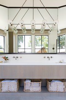 Above the sink in the master bath, a Trapeze 10 pendant crafted from oil-rubbed bronze and porcelain is one of the highlights.