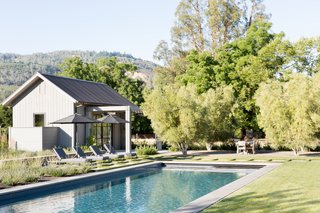 The pool house patio, featuring Harbour Outdoor sun loungers.