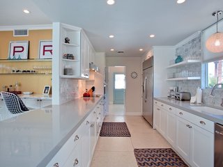 The contemporary kitchen is stocked with stainless steel appliances.