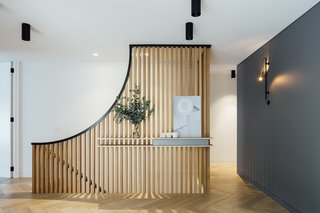 Fluted timber screens add warmth and texture to the open-plan living area.