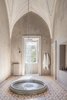 Modern home with Porcelain Tile Floor and Wall Lighting. Reminiscent of an art installation, the rain shower in the Royal Junior suite cascades from a nearly 20-foot-high ceiling into a basin designed by Italian artist Andrea Sala. Photo 11 of Palazzo Daniele
