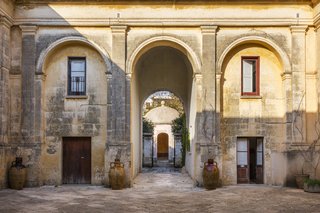 Palazzo Daniele's stunning courtyard. In the distance is the circular-domed Kaffeehaus, a one-time aristocratic hangout where guests can now savor candle-lit dinners.