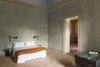 Modern home with Bedroom, Bed, Wall Lighting, Night Stands, Terra-cotta Tile Floor, and Dresser. All the suites effortlessly juxtapose history and modernity. Photo 7 of Palazzo Daniele