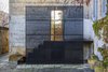 Modern home with Outdoor, Side Yard, Stone Patio, Porch, Deck, and Large Patio, Porch, Deck. Concrete stairs lead from the kitchen to the pool area. A peekaboo perforated screen crafted from black metal allows guests to see the activity unfolding inside. Photo 13 of Palazzo Daniele