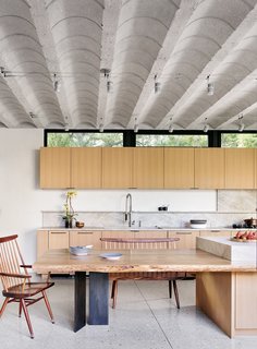 In the kitchen, the concrete, barrel-vaulted ceiling adds an industrial air.