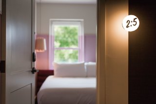 The door markers at the Russell, crafted by New York lighting studio Rich Brilliant Willing, are reminiscent of Biblical verses.
