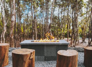 Log seating around the fire pit reinforces Kūono's relationship with nature.