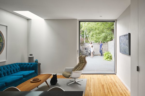 Midcentury-inspired seating adds color in the family room, which leads to the deck in back.