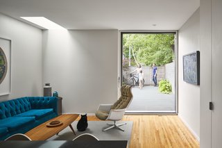 Midcentury-inspired seating adds color in the family room, which leads to the deck in back.