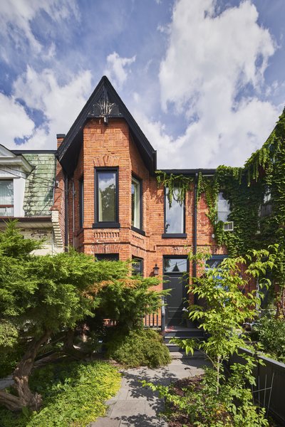 The modern extension in back belies the historic brick facade.