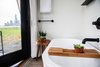 Modern home with Bath Room and Soaking Tub. The free-standing soaking tub, found behind an 8-foot-high pocket door. Photo 7 of Outlook Shelter