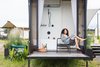 Modern home with Bath Room and Soaking Tub. The rain shower and tub combo, featuring matte black plumbing fixtures. Photo 6 of Outlook Shelter