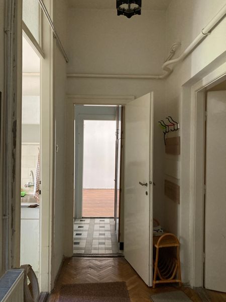 The entry to Sarolta Hüttl’s apartment was originally cloaked in chevron parquet flooring, a feature that extended throughout the home.
