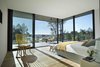 Modern home with Bedroom, Table Lighting, Storage, Bench, Chair, Light Hardwood Floor, Night Stands, Medium Hardwood Floor, Bed, and Floor Lighting. La Vinya, PGA Golf Resort | Studio RHE Photo 5 of La Vinya, PGA Golf Resort