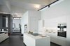 Modern home with Kitchen, Cooktops, Ceramic Tile Floor, Concrete Floor, White Cabinet, Granite Counter, Marble Counter, Accent Lighting, Wall Oven, Stone Counter, Quartzite Counter, Engineered Quartz Counter, Range, Wood Cabinet, Limestone Floor, Slate Floor, Porcelain Tile Backsplashe, Porcelain Tile Floor, Stone Tile Backsplashe, and Drop In Sink. La Vinya, PGA Golf Resort | Studio RHE Photo 9 of La Vinya, PGA Golf Resort