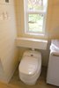 Modern home with Laminate Floor. The composting toilet also allows for handy built-in shelves to conceal the vent system while the venting window allows natural light to flow into the space. Photo 16 of Innisfree Anarres