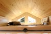 Modern home with Bedroom, Recessed Lighting, Bed, and Plywood Floor. The secondary loft, located over the living room, is a perfect retreat for guests or leaves room for an expanding family. Natural light is brought in by the rake windows that complement and shadow the roof line. Photo 9 of Innisfree Anarres