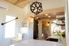 Modern home with Kitchen, Subway Tile Backsplashe, Range Hood, Cooktops, Recessed Lighting, White Cabinet, Quartzite Counter, Pendant Lighting, Undermount Sink, and Laminate Floor. The storage staircase feature a space for hanging clothes, open shelves a 12 cu. ft. stainless fridge and a floor to ceiling pull-out pantry. Photo 17 of Innisfree Anarres