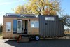 Modern home with Exterior, Metal Siding Material, A-Frame RoofLine, Wood Siding Material, Metal Roof Material, and Tiny Home Building Type. Natural cedar and steel siding are used to create an appealing and modern exterior that will blend with it's surrounding environment. Solar panels on the roof capture renewable energy to the battery bank located in the front of the tiny home. The passive solar heat panel is located on the side of the home and provides back-up heat for the home owners during the day. Photo 10 of Innisfree Anarres