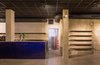 Modern home with Kitchen, Tile Counter, Track Lighting, Wall Lighting, Accent Lighting, Concrete Floor, and Ceramic Tile Backsplashe. The cobalt blue ceramic coated bar emerges from the floor. Photo 7 of IMOOD Restaurant