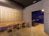 Modern home with Dining Room, Chair, Wall Lighting, Bench, Concrete Floor, Track Lighting, and Table. The sign has been designed by Nada. Photo 5 of IMOOD Restaurant