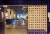 Modern home with Kitchen, Tile Counter, Concrete Floor, Ceramic Tile Backsplashe, Accent Lighting, Ceramic Tile Floor, Wall Lighting, Ceiling Lighting, and Track Lighting. The latticework suggests transparencies from the kitchen. Photo 9 of IMOOD Restaurant