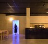 Modern home with Kitchen, Tile Counter, Ceramic Tile Backsplashe, Concrete Floor, Wall Lighting, Accent Lighting, and Track Lighting. The translucent PVC slats are the entrance to the toilet. Photo 12 of IMOOD Restaurant