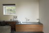 Modern home with Bath Room, Stone Counter, Open Shower, Freestanding Tub, Wood Counter, Ceiling Lighting, Concrete Floor, Undermount Sink, and Whirlpool Tub. Teak Bath with Lift. Custom Woodwork by Rowan Photo 9 of 2 Barns