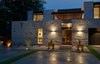 Modern home with Exterior, Stone Siding Material, House Building Type, Stucco Siding Material, and Flat RoofLine. Front close up, dusk Photo 2 of MM31
