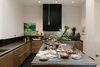 Modern home with Kitchen, Beverage Center, Wine Cooler, Dishwasher, Microwave, Range, Range Hood, Ice Maker, Concrete Counter, Ceiling Lighting, Recessed Lighting, Pendant Lighting, Cooktops, Drop In Sink, Dark Hardwood Floor, Refrigerator, Wood Cabinet, and Porcelain Tile Backsplashe. Chef's kitchen and serving station Photo 8 of The Mitz - A place to meet!