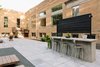Modern home with Outdoor, Large Patio, Porch, Deck, Raised Planters, Boulders, Landscape Lighting, Pavers Patio, Porch, Deck, Walkways, Hardscapes, Shrubs, Wood Fences, Wall, Stone Patio, Porch, Deck, Side Yard, and Post Lighting. Outdoor looking East Photo 5 of The Mitz - A place to meet!