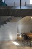 Modern home with Dining Room, Table, Light Hardwood Floor, and Chair. Iron loft and concrete staircase Photo 7 of Blue and concrete apartment