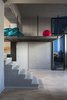 Modern home with Living Room, Accent Lighting, Light Hardwood Floor, and Ceiling Lighting. Concrete staircase and iron loft Photo of Blue and concrete apartment