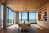 Modern home with Chair and Medium Hardwood Floor. Dining Room looking West towards Lake Michigan Photo 15 of St Joseph Beachfront Home