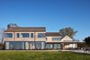 Modern home with Exterior, House Building Type, Shed RoofLine, Beach House Building Type, and Wood Siding Material. View of Outdoor pool and kitchen, looking East Photo 3 of St Joseph Beachfront Home