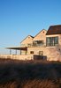 Modern home with Exterior, Wood Siding Material, House Building Type, Shed RoofLine, and Beach House Building Type. Looking North/West Photo 7 of St Joseph Beachfront Home