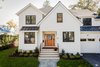 Modern home with Windows, Wood, and Double Hung Window Type. The front facade was purposefully created to minimize the size of the home and make sure it fit in to the scale of the surrounding neighborhood. Photo of Mid Century Style